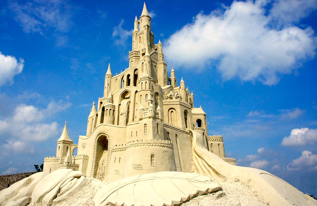 A beautiful castle made of sand... so much work went into making it, but as the tide comes in it will disappear.  Just like a sand castle, everything in life is temporary.