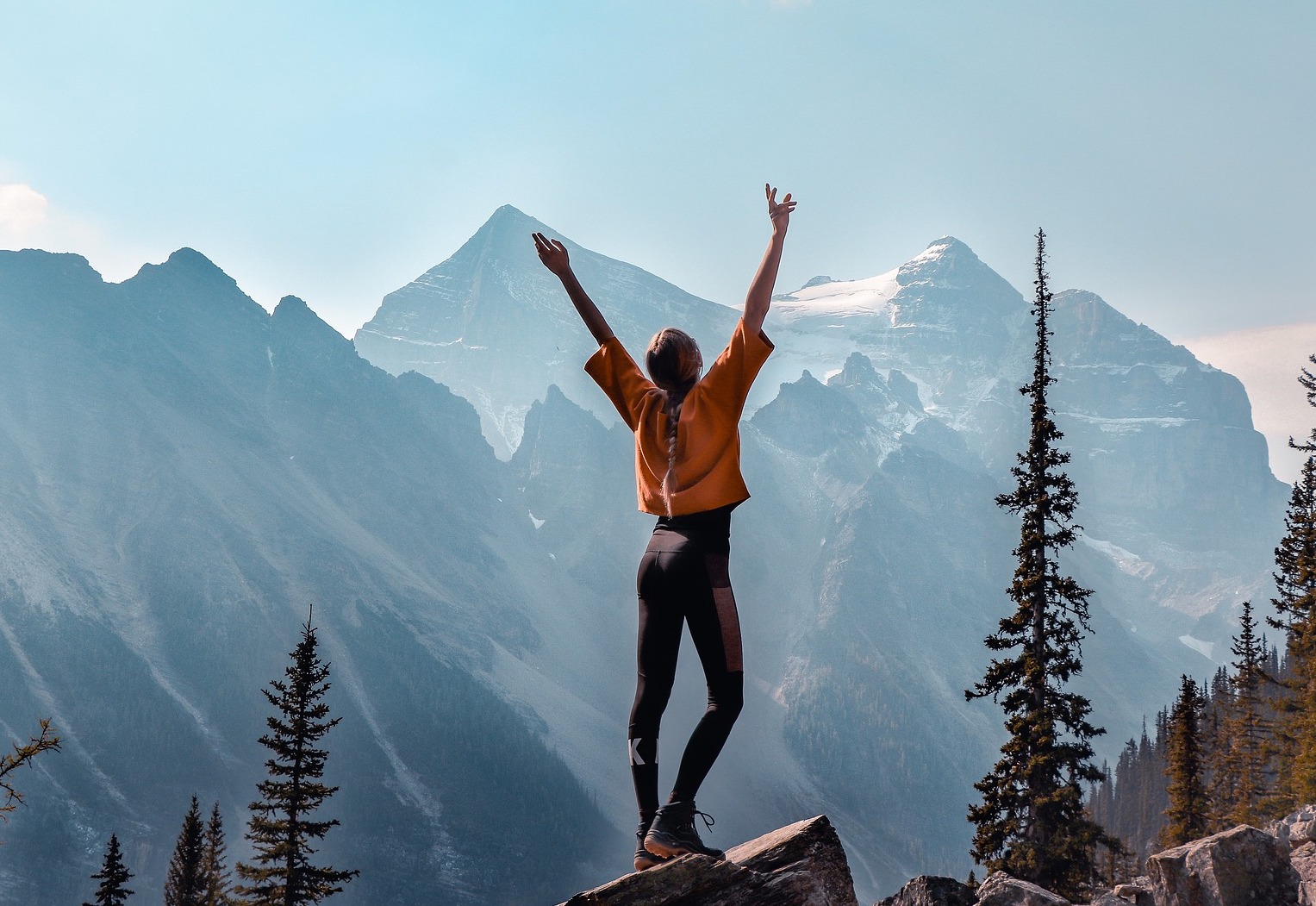 Girl celebrates reaching the highest part of a mountain