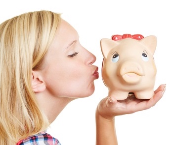 Woman kissing her piggy bank